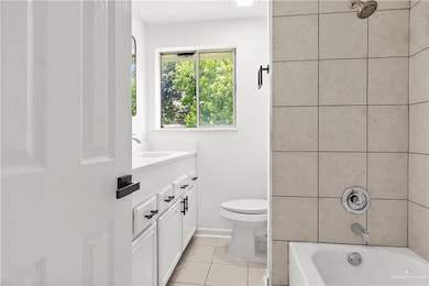 Bathroom with vanity, tile patterned flooring, and bathing tub / shower combination