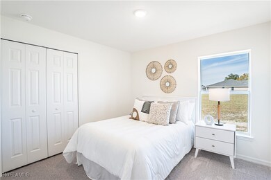 Carpeted bedroom featuring a closet and baseboards