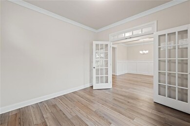 Unfurnished room featuring an inviting chandelier,