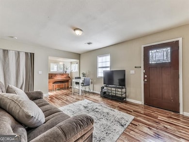 Living room featuring a textured ceiling and hardw