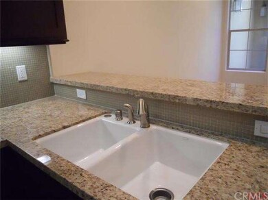 Close-up view of granite countertop and glass-tile