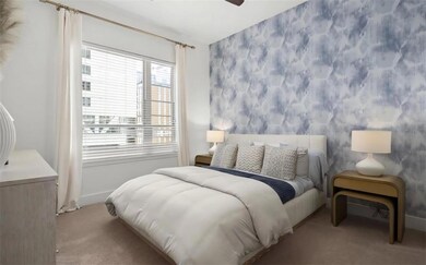 Carpeted bedroom featuring ceiling fan
