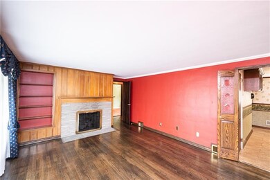 Appreciate the living room's original dark stained
