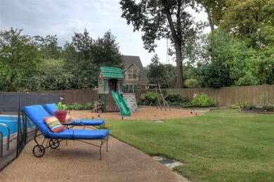 Grassy side yard next to pool