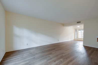 Empty room with wood finished floors and baseboards