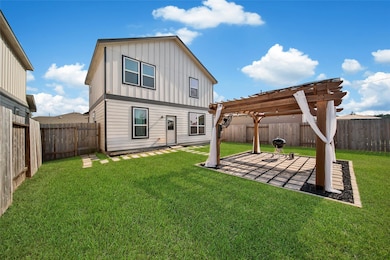 Covered patio with pergola, natural gas hookup, and plenty of room for entertaining