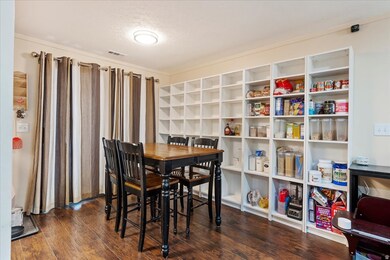 Dining room featuring dark wood finished floors and a textured ceiling