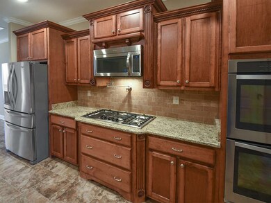 This picture shows the fine furniture detail of the cabinetry plus the handy pot filler above..no more carrying the spaghetti pot across the kitchen.