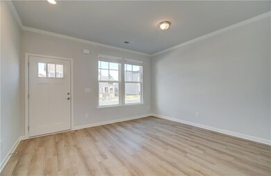 Entrance foyer with light hardwood / wood-style floors and ornamental molding