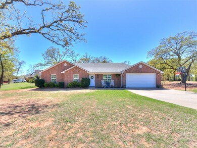 Single story home featuring a garage and a front y