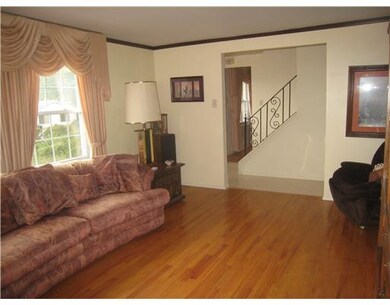 Living Room. Hardwood and crown molding throughout
