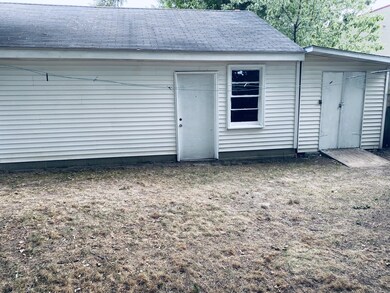 SIDE VIEW OF GARAGE AND STORAGE SHED