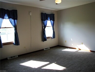 Double windows in the master bedroom overlook the 