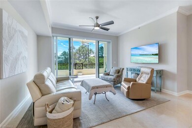 Living area with crown molding, a ceiling fan, and baseboards