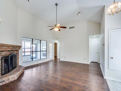 Unfurnished living room with a brick fireplace, da