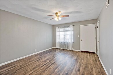 Spare room with ceiling fan and dark wood-type flo