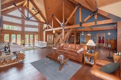 Living area with high vaulted ceiling, washer / dr