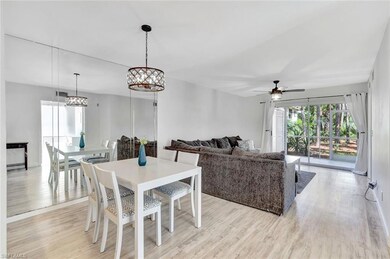 Dining room featuring light wood finished floors, a ceiling fan, and a chandelier
