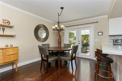 The dining area opens to both the kitchen and family room with beautiful laminate flooring, crown molding, scraped ceilings, and French doors to the entertainers backyard!
