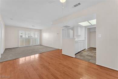 Unfurnished living room featuring light wood-style flooring and a ceiling fan