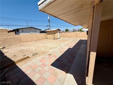 View of patio with a fenced backyard, an outdoor s