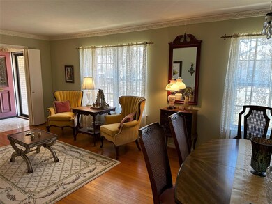 Formal Living Room with Hardwood Flooring and Larg