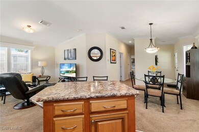 Kitchen featuring light carpet, a kitchen island,