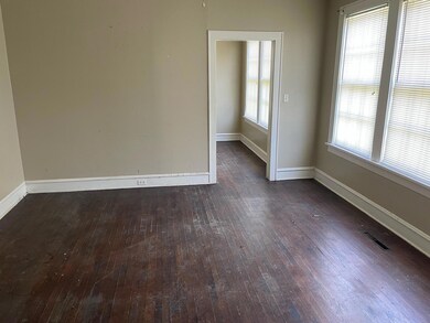 Empty room with dark hardwood / wood-style floorin