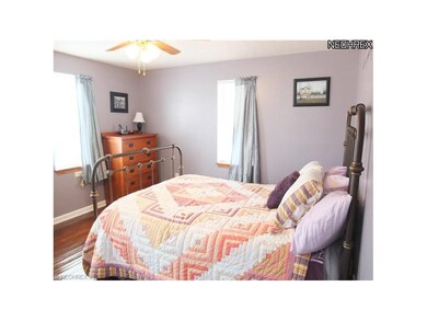 Master bedroom with hardwood floors.