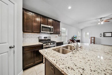 This kitchen is a dream with a gas range, walk-in pantry, and plenty of space to work.