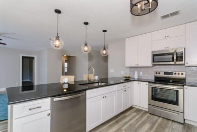 The kitchen looks out into the living room.  The e