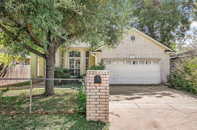 View of front of house featuring concrete driveway, brick siding, and an attached garage