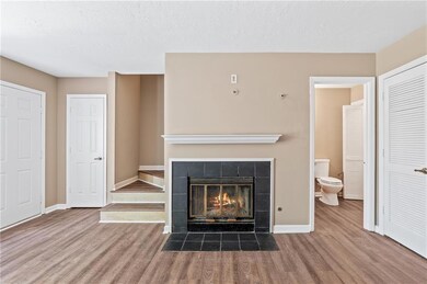 Unfurnished living room featuring baseboards, wood
