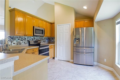 Kitchen with stainless steel appliances, vaulted c