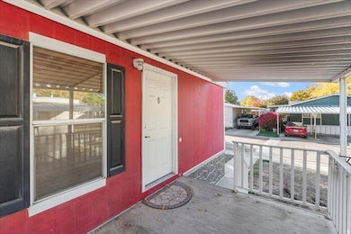 Property entrance with an attached carport and covered porch