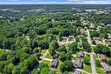 Aerial view of residential area featuring a forest