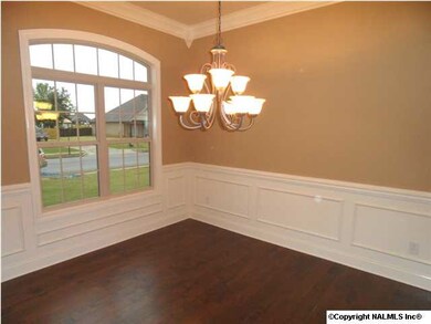 Dining room has 10 foot ceilings, wood floor, chair rail with shadow box underneath.