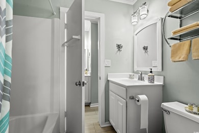 Bathroom featuring vanity, shower / bathtub combination with curtain, and light tile patterned floors