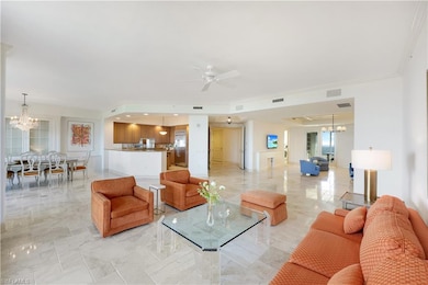 Living room featuring ceiling fan with notable cha