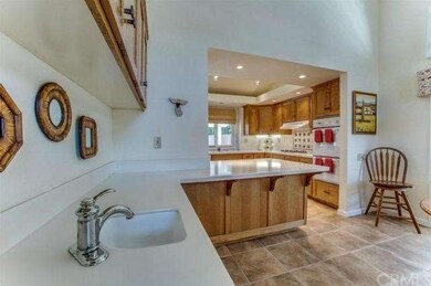 WET BAR HAS CORIAN COUNTERS & LARGE BREAKFAST BAR