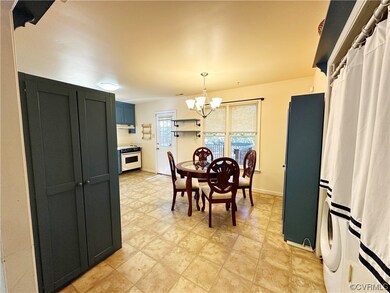 Dining space with light tile flooring and a chande