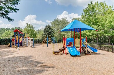 Community play area featuring view of wooded area