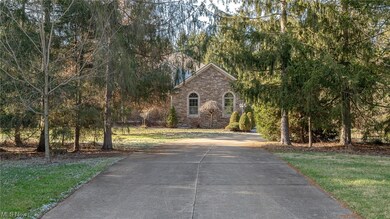 View from street. Nestled in a forest of evergreens, the trees provide privacy and shade