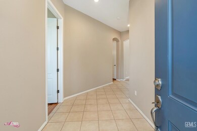 Entry into wide tiled hallway.  Door at left is to the front bedroom