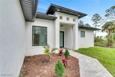 Doorway to property with a lawn and stucco siding