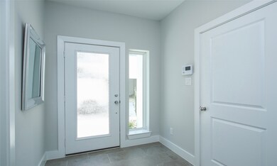Glass entry door with side window.