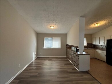 Kitchen featuring plenty of natural light, dark co