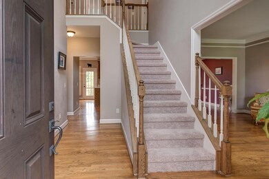 Sand and finish hardwood floors in the entry set the stage for a traditional styled look. 