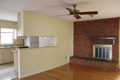 Brick wall and hearth with wood burning fireplace.