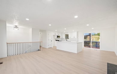 Unfurnished living room featuring light wood-style flooring, recessed lighting, and a textured ceiling